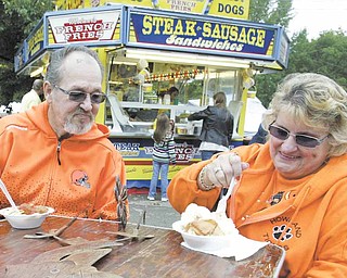 The Oktoberfest wouldn’t be complete without food, and James and Charlotte Gosnell of Howland sample some. James Gosnell said they attended to help pick up the economy. About 10,000 people attended the annual event in Boardman Township Park on Sunday.
