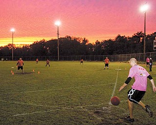 Adam Kagarise, of team, 4U2NV, winds up before a kick during a kickball game at Oakland Field on Youngstown’s East Side on Wednesday evening.