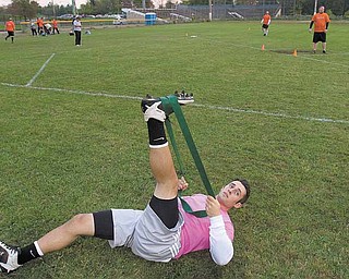 BobBovara, of Boardman, stretches out before the second game in a kickball doubleheader at Oakland Field on
Wednesday evening.