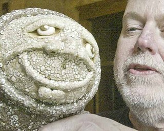 James S. Rodgers Jr., a Youngstown-based ceramic and pottery artist, shows an example of his work during the “Artists by the River” fundraiser Sunday sponsored by the Altrusa Club of Youngstown. Proceeds will benefit the clubs’s Plant the Seed to Read event next March 26.