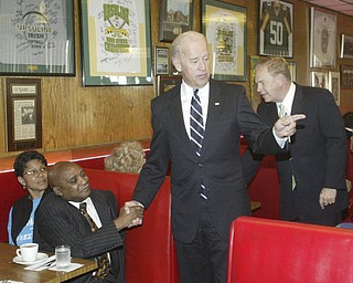 William d Lewis The Vindicator VP Joe Biden shakes hands with Artis Gillam, at left is gillams wife Anne. Ohio gov Ted Strickland is at right during visit to the Golden Dawn Monday by the VP.