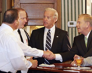 William D LEwis The Vindicator Ohio Gov Ted Strickland shakes hands with John Naples, one of the owners of the Golden Dawn during a visit Monday by VPJoe Biden (center) to Youngstown. at far left is Benny Naples, another owner.