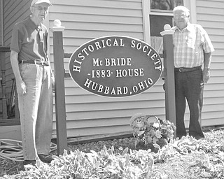 Visitors will no longer have to wonder when the McBride House, at 27 Hager St., Hubbard, was built. Those attending the next open house from 2 to 5 p.m. Oct. 10 have only to look at the newly refurbished sign displayed by, Ralph Cooper, left, and Fred Thomas, members of the Hubbard Historical Society, to learn the house was built in 1883. Tours of the historical house are regularly scheduled for the second Sunday of each month. For information on scheduling other tours, contact Cecilia Cooper at 330-534-4247.