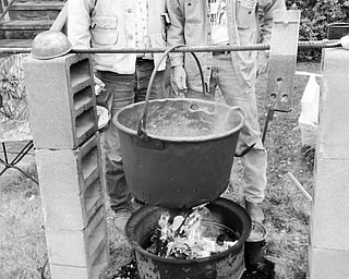A fire was kept burning beneath a huge copper kettle all day on Sept. 25 by members of the Salem Historical Society as they demonstrated how settlers once made apple butter in the outdoors. Among those cooking breakfast, soup and coffee over the open fire while helping to produce 40 jars of fresh apple butter were John Gilbert, left, and Tim Burkey. This year’s batch included apples harvested from a tree in the Historical Society’s garden. The apple butter will be sold in pint and half pint jars by the society at 208 S. Broadway Ave., Salem. For additional information call 330-337-8514 or 330-332-0129.