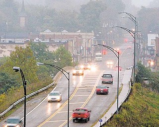 At twilight on a recent night, the city of Girard sits beyond the Girard-McDonald Viaduct, where a portion of the lights are out. There is a question on which governmental agency Ñ Girard or Trumbull County Ñ is responsible for maintenance of the lights. The city is making inquiries to figure it out.