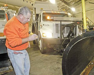 Rick Sause, an employee with the Ohio Department of Transporation, inspects a snowplow Wednesday during an annual preseason inspection. ODOT District 4, which encompasses Mahoning, Trumbull, Ashtabula, Portage, Summit and Stark counties, had a “dry run” Wednesday morning and tested equipment for winter weather at its Canfield garage.