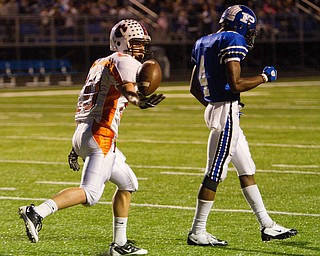 Geoffrey Hauschild|The Vindicator.Howland's Dominic Termine (20) recovers a live ball as the original ball carrier, Poland's Darius Patton (4), assumes the play is over allowing Termine to run the ball over 70 yards for a touchdown during the first quarter of a game at Poland High School on Friday evening.