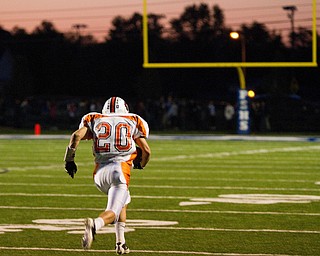 Geoffrey Hauschild|The Vindicator.Howland's Dominic Termine (20) recovers a ball most players thought was dead allowing him a 70+ yard run ending in a touchdown during the first quarter of a game at Poland High School on Friday evening.