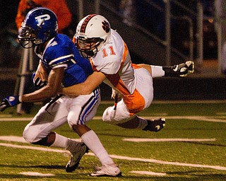 Geoffrey Hauschild|The Vindicator.Howland's Dan Ebert (11) brings down Poland's Darius Patton (4) during the first quarter of a game at Poland High School on Friday evening.