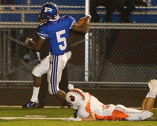 Geoffrey Hauschild|The Vindicator.Poland's Dom Patton (5) stays a step ahead of Howland's Kenny Pozega (6) on his way into the endzone for a touchdown during the first quarter of a game at Poland High School on Friday evening.