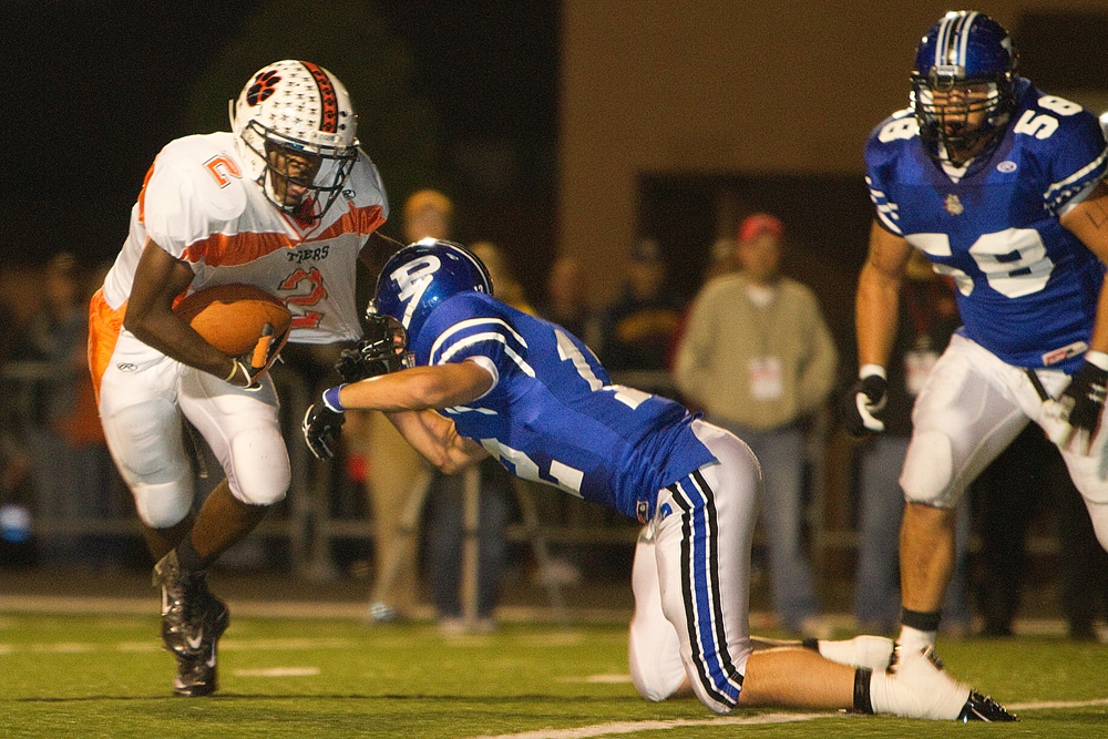 Geoffrey Hauschild|The Vindicator.Howland's Tony OSborne (2) makes his way down field but is tripped up by Poland's Alex Argeras (12) during the second quarter of a game at Poland High School on Friday evening.