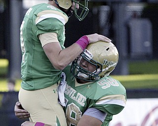 Usuline QB Paul Kempe gets congrats from Pete Wearsch after scoring 2point conversion during first quarter action Friday, Oct. 8, 2010.