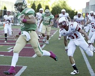 William D Lewis The Vindicator UsulineQB PaulKempe eludes St Charles #31to score two point conversion during first qtr action Friday.
