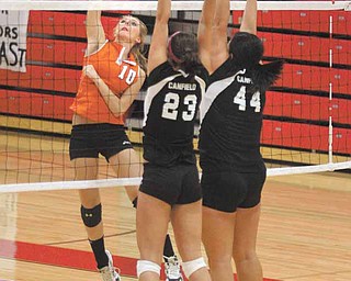 VOLLEYBALL - (10) Kylie Kohler of Springfield spikes the ball as (23) Hannah Milstead and (44) Mary-Kate Andrews go for the block Monday night. - Special to The Vindicator/Nick Mays