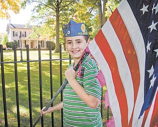 Jeffrey Vrabel Jr., 11, of Poland, displays one of the tattered American flags that will be retired as part of the Flags Over Poland fundraiser conducted by the Sons of the American Legion Squadron 15. The group hopes that 28 new American flags will be in place in front of Poland Village Hall on South Main Street by Veterans Day, Nov. 11..