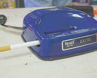 Cheap Tobacco specializes in roll-your-own cigarette products and tools like this manual-rolling machine. Rising cigarette prices, and the economic downturn, have driven many smokers to roll their own cigarettes. .