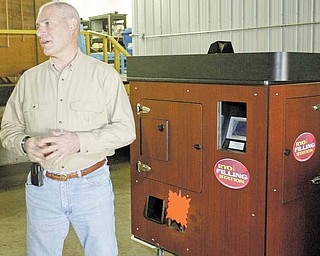 Phil Accordino, owner of RYO Machine Rentals, stands near an RYO Filling Station at the companyÕs manufacturing facility in Girard. RYO has stopped production after a recent federal ruling banned the use of the machines in retail tobacco stores..