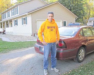 Todd Hanks stands outside his South Leavitt Road home near the spot where he discovered items from his garage and another home Sept. 25. He suspects that thieves left the items on the edge of the driveway so they could pick them up later. His was one of many break-ins in Trumbull County in recent weeks..