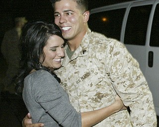 William D. Lewis|The Vindicator Marine reserve cpl. Nick Marchese of Niles embraces his girlfriend Kelsy Mikesell upon arriving at the Youngstown Airbase from Afghanistan Thursday night.