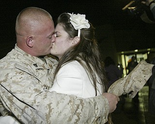 William D. Lewis|The Vindicator Marine Reservist Cory May kisses his wife Torrie May upon arriving at the Youngstown Airbase from Afghanistan Thursday night. They are from Cambridge, OH.