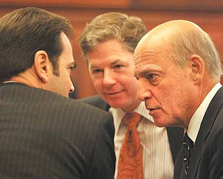 George A. Stamboulidis, left, back to camera, lawyer for Anthony M. Cafaro Sr.; John F. McCaffrey, center, lawyer for the Ohio Valley Mall Co. and the Marion Plaza Inc.; and Martin G. Weinberg, another Cafaro lawyer, huddle at the Thursday hearing in Mahoning County Common Pleas Court. Visiting Judge Wolff summoned grand jurors to the courthouse, where he admonished them to keep their oath of secrecy to avoid breaches.