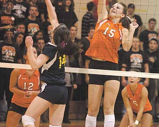 Mineral Ridge’s Meghan Garland (15) prepares to return a ball sent over the net by United’ Rachel Sell (14) during Thursday’s game at Mineral Ridge High School.