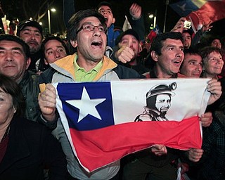 People celebrate the end of the successful rescue operation that freed 33 trapped miners from the San Jose mine in Copiapo, Chile, Wednesday Oct. 13, 2010. The 69-day underground ordeal reached its end Wednesday night after 33 trapped miners were hauled up in a cage through a narrow hole drilled through 2,000 feet of rock. (AP Photo/Martin Mejia)