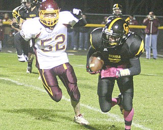 FOOTBALL - (7) Brian Orr tries to get away from (52) Robbie Grahovac Friday night at Crestview. - Special to The Vindicator/Nick Mays