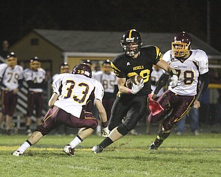 FOOTBALL - (28) Andrew Mayer tries to get past (33) Alex Dickey as (78)Christian Bowden tries to get in on the play Friday night at Crestview. - Special to The Vindicator/Nick Mays