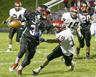William D. Lewis|The Vindicator Campbell's Ja Les Hughes finds a hole and eludes Girard'sBryan Daugherty during 1 rst half action Friday at Campbell.