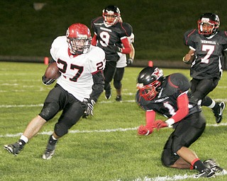 William D. Lewis|The Vindicator Girard's Zach Cochran eludes Red Devil's Claxton LeBron during 1 rst half action Friday at Campbell.