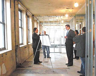Dominic Gatta III, left, shows U.S. Rep. Tim Ryan of Niles D-17th, plans for apartments on the second floor of the Federal Building. The Gatta Co. of Niles is in the process of renovating the Youngstown landmark..