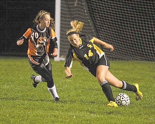 (14) Anna Hardenbrook of Crestview tries to keep the ball from (10) Alyssa Casto during their game Monday night in New Middletown.