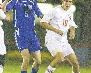 Poland High’s Dan Montgomery, left, and Niles’ C.J. Cicero go for the ball during Tuesday’s Division II boys soccer tournament game at Bo Rein Stadium in Niles. The Red Dragons advanced with a 3-2 victory.