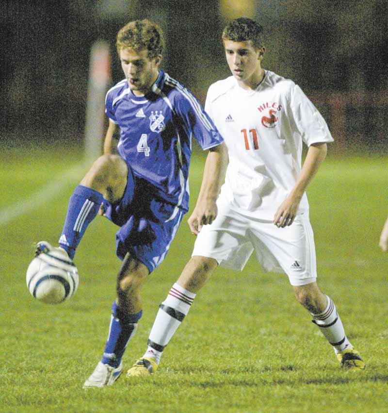 Kevin Krumpak (4) of Poland controls the ball as Niles’ Bruce Hilemann defends during the boys Division II soccer
tournament game in Niles on Tuesday night.