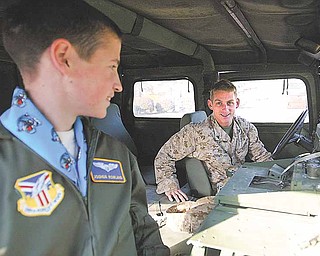 Cpl. Randy Kibler, of the United States Marine Corps, gets ready to take Joshua Rowland, of Canfield, for a ride in a military HUMVEE just after Rowland was sworn-in as an honorary Air Force Reserve 2nd lieutenant Wednesday. 