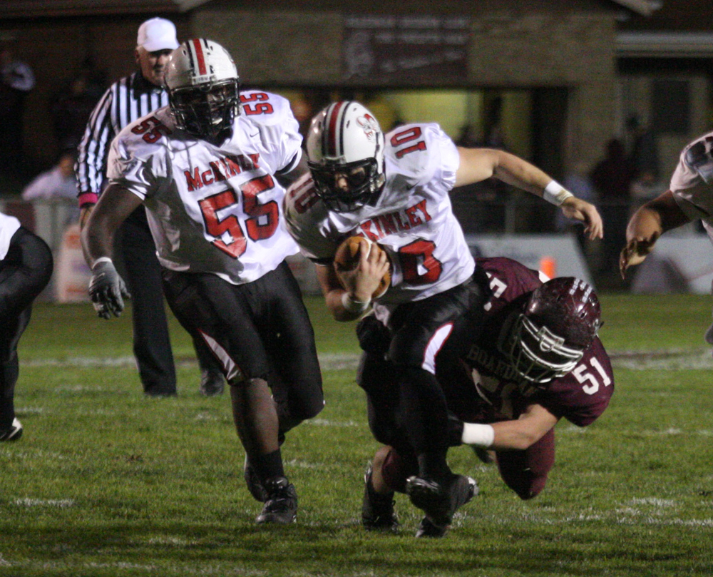 FOOTBALL - (10) Kyle Ohradzansky can't shake (51) Zach Machuga during their game Thursday night. (55) Philleano Kennard tries to get a block. - Special to The Vindicator/Nick Mays