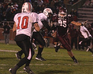 FOOTBALL - (95) Eric Yovanovich tries to get to (10 Kyle Ohradzansky during their game Thursday night. - Special to The Vindicator/Nick Mays