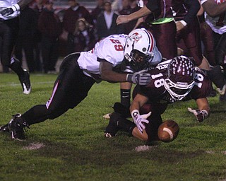 FOOTBALL - (18) Nick Buonavolonta recovers his fumble as (29) Johnny Duncan tries to get in on the play during their game Thursday night. - Special to The Vindicator/Nick Mays