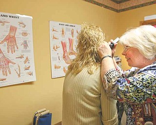 The Austintown Fitch High School health center is run by Janet Gorsuch, a nurse practitioner, right, who is able to perform physicals for all sports teams and administer treatments such as the flu shot for students and the community.