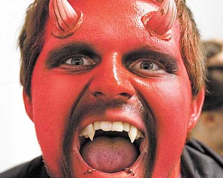 Justyn Newcomb of Niles prepares for another weekend at the Canfield Scaregrounds. He is sure to scare a few folks as they make their way through the haunted house and hayride.