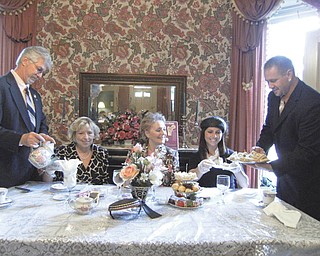 Perfect setting: The Upton House, 380 Mahoning Ave., Warren, was the setting recently for an afternoon tea hosted by the GFWC/Warren Junior Women’s League Home Life Committee in conjunction with a meeting and a talk on “Strong Bones — Strong Body” by Shirley Lisk, a health educator from St. Joe’s at the Eastwood Mall, who presented facts about osteoporosis and how it is treated. Keith Koss, at left, and Lance Koss serve tea to, from left, Vicki Koss, event chairwoman; the guest speaker; and Allison Fee, co-chairwoman. Among the hostesses for the tea (but not pictured) were committee members Darlene Fealko, Melanie Gemmell, Vanessa Koper and Pam Vines. To raise funds for the National Osteoporosis Foundation, committee members crafted and sold pearl bracelets.