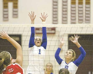 Hubbard’s Marquette Gasser (1) and Megan DeMaiolo (8) go up for a shot against Field’s Emily Ulreich (20) and Hannah Fisher (15) during a Division II district volleyball semi final Wednesday in Boardman. The Eagles were eliminated three games to one.