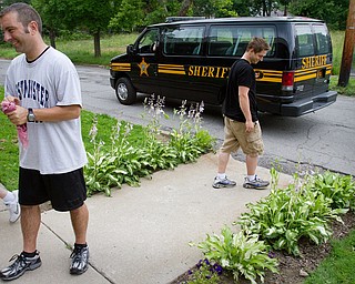 Geoffrey Hauschild|The Vindicator.6.15.2010.Portage County Sheriff's Deputy Mike Bussinger drives away from Ohio Valley Teen Challenge after asking residents Scott Fabry and John Wilden of the whereabouts of a dropout. OVTC notified the police after a dropout, who was at the center in lieu of correctional time, returned to the center seeking a refund on their deposit.