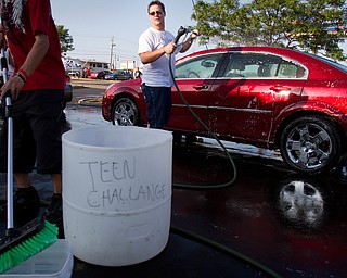 Geoffrey Hauschild|The Vindicator.6.18.2010.OVTC resident Michael Malott washes cars during the annual crane fundraiser for OVTC in the Kmart parking lot on U.S. 224 in Boardman.