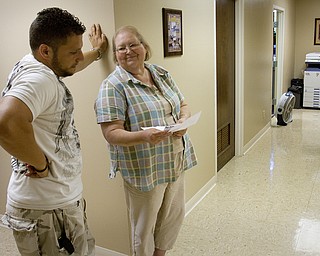 Geoffrey Hauschild|The Vindicator.6.29.2010.OVTC Director of Operations, Bob Pavlich, speaks with administrator, Cathy Barnett, wife of Executive Director, Roy Barnett, at OVTC.
