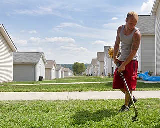 Geoffrey Hauschild|The Vindicator.7.26.2010.OVTC intern Greg Todd leads a work crew in landscaping around the neighborhood of Arlington Heights.