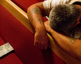 Geoffrey Hauschild|The Vindcator.8.4.2010.OVTC resident John Anderson prays during the group's weekly Wednesday night church service at Youngstown Christian Assembly on Youngstown's South Side. The men have chapel service every morning, and typically attend a church service every Wednesday evening and Sunday morning.