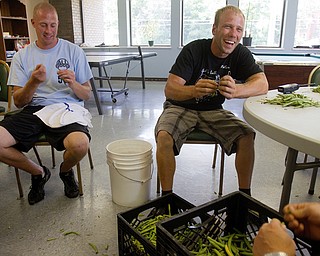 Geoffrey Hauschild|The Vindicator.8.5.2010.OVTC student, Ian Zimomra, and intern, Greg Todd, help pick beans in the cafeteria of the OVTC center. The beans are part of a donation to the center from a local farmer who hires the men to work and donates food during the warmer months.