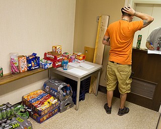 Geoffrey Hauschild|The VIndicator.8.5.2010.OVTC resident Justin Hensley buys pop and snacks from intern Sean Wilson, who works at the center's store which is open once a week for a short period of time.